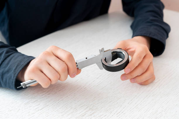 istock engineer hand working and measure the parts with caliper tool 1302479267