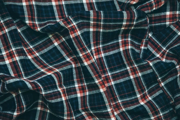istock Woolen checkered fabric texture. Warm winter blanket 1302479290