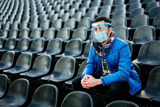istock Portrait of worried man with protective face mask and face shield 1302483607