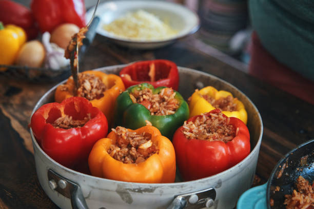 istock Preparing Stuffed Bell Peppers with Ground Meat in Tomato Sauce 1302485015