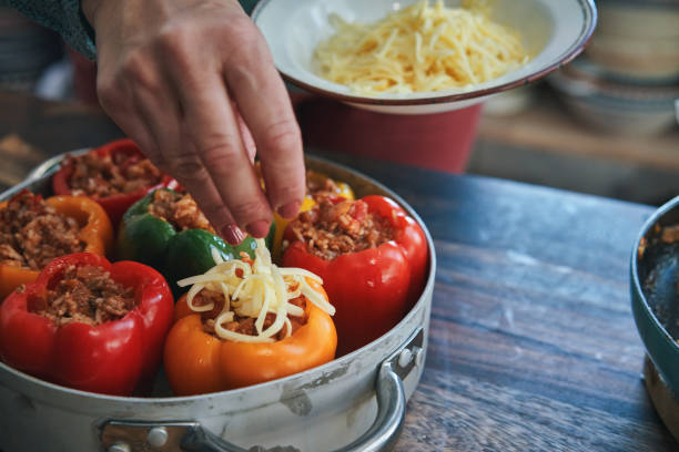 istock Preparing Stuffed Bell Peppers with Ground Meat in Tomato Sauce 1302485661