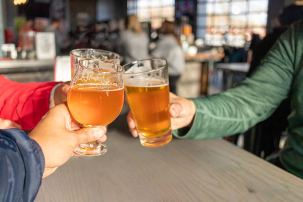 istock Friends celebrating with beers in a pub 1302486820