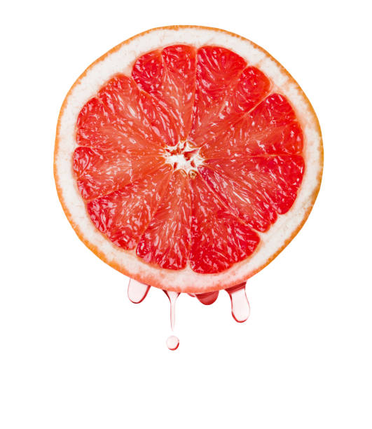 istock Ripe grapefruit and drops of juice 1302487130