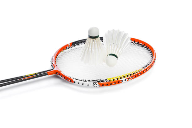 Badminton rackets and feather shuttlecocks Badminton rackets and feather shuttlecocks isolated on white background badminton racket stock pictures, royalty-free photos & images