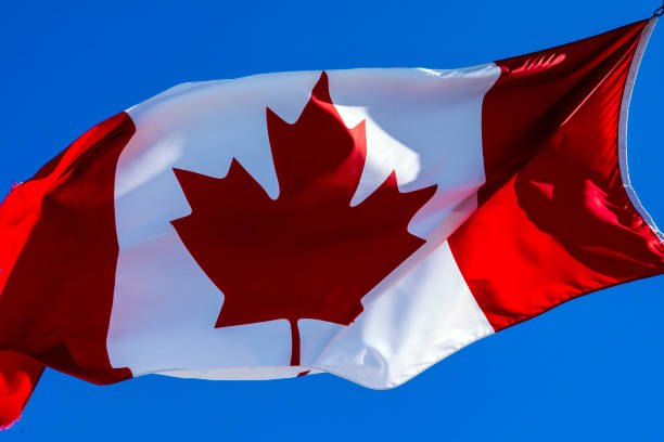 Candian flag Candian flag canada flag blue sky clouds stock pictures, royalty-free photos & images