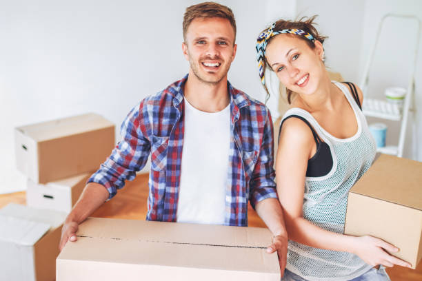 istock Young couple working as a team. Unpacking boxes in a new apartment 1302489092