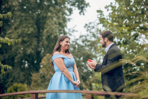 istock Man with red little box and joyful woman 1302490391