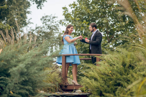 istock Man puts a ring on happy woman 1302490398