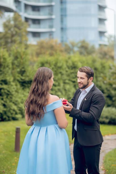 istock Man proposing and woman with back to camera 1302490425