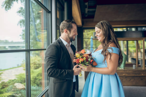 istock Happy couple standing in cafe opposite each other 1302490621