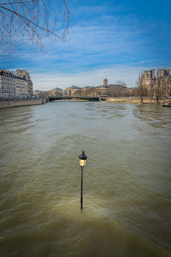 Paris, France - 02 12 2021: Panoramic view of the Seine and a Street lamp in  Louis Aragon Square from Saint-Louis Island during the Seine flood
