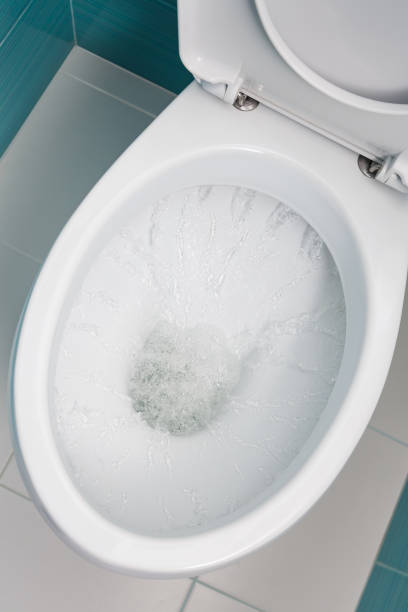 istock water flowing into a white toilet 1302493810