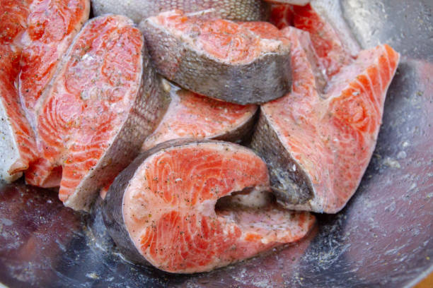 istock Fresh trout steaks are marinated in a metal bowl before cooking 1302493881