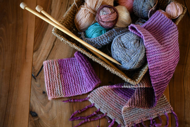 istock Accessories for knitting in basket ( yarn, needles) and scarf 1302494609