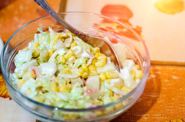 Homemade vegetable salad with cabbage and corn with mayonnaise.