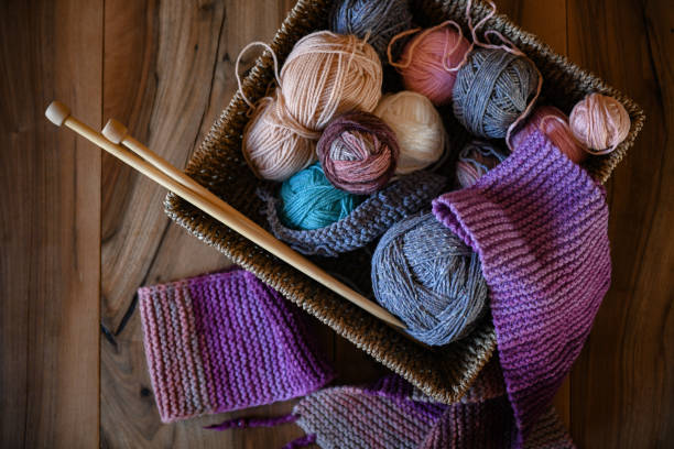 istock Accessories for knitting in basket ( yarn, needles) and scarf 1302494698