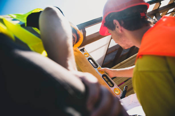 istock Two manual workers installing a wooden fence 1302494781