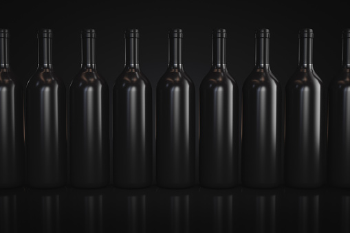 A row of wine bottles. Alcoholic topics.