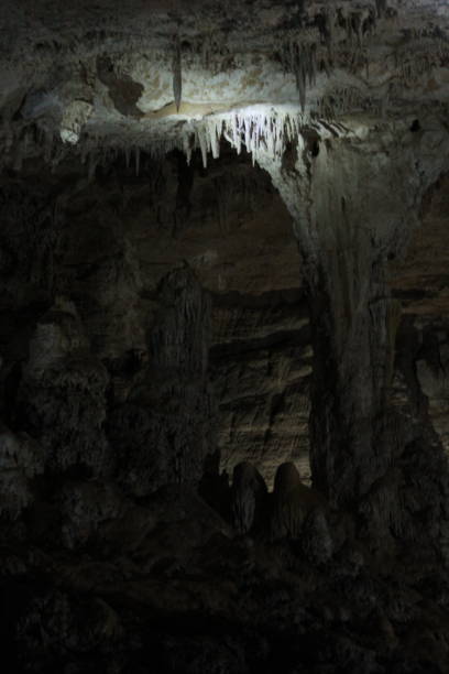 istock Cave interior with stalactites and stalamites and reflecting light 1302496259