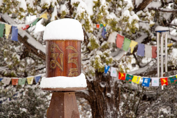 roue et drapeaux de prière dans la neige d’hiver - prayer wheel photos et images de collection