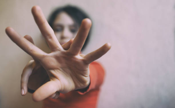 istock Little girl protects herself with open palm 1302498969