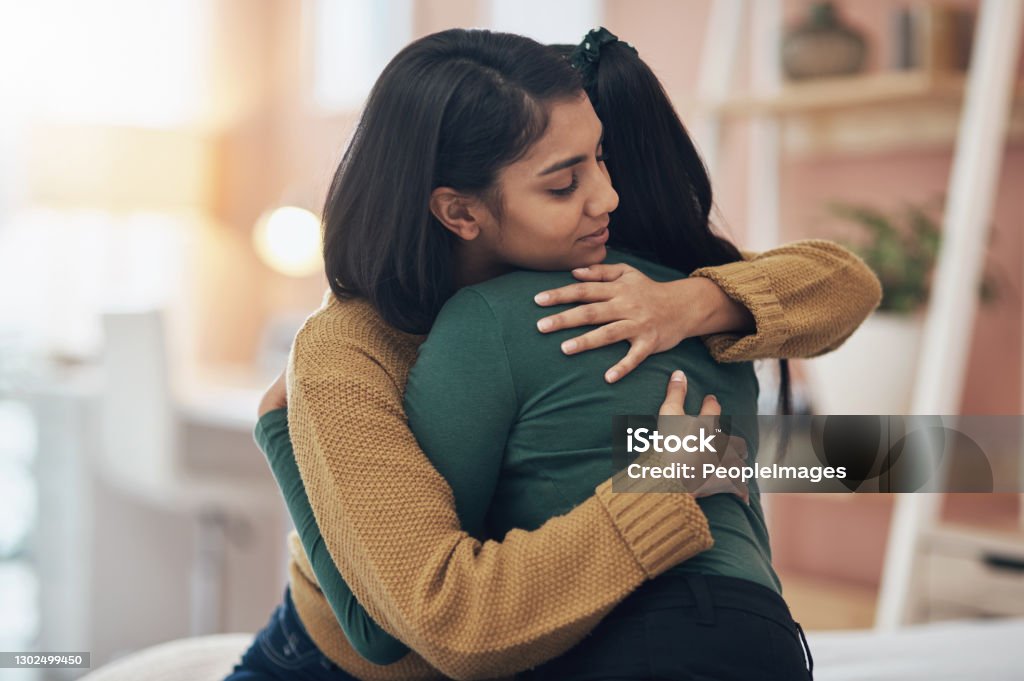 I'll always be here to support her Cropped shot of two young women embracing each other at home Embracing Stock Photo