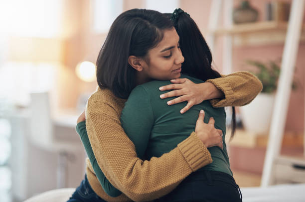 I'll always be here to support her Cropped shot of two young women embracing each other at home crying photos stock pictures, royalty-free photos & images