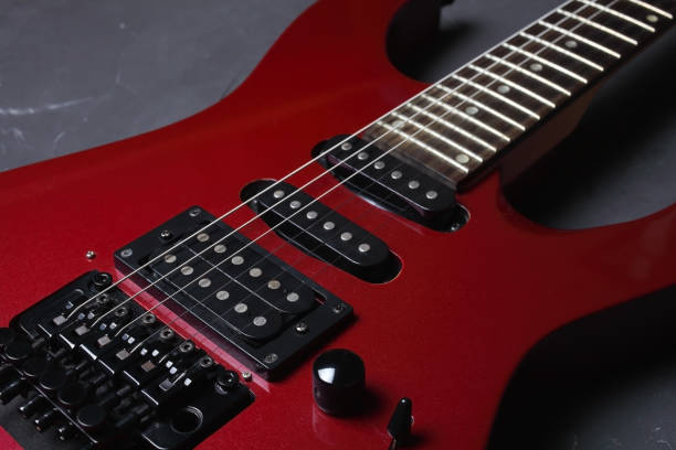 istock Red electric guitar on dark concrete background, close-up, selective focus 1302500500