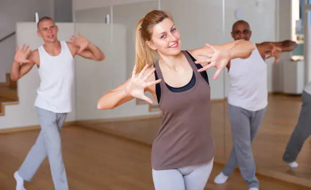 Photo of Woman dancing at group lesson in studio