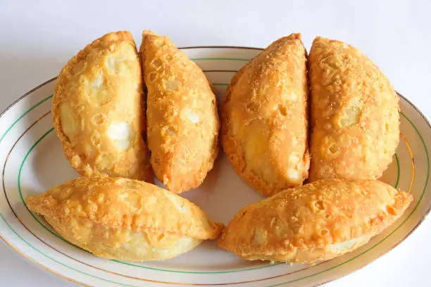 Kajjikayalu a traditional Telugu delicacy from Andhra Pradesh , South India is a sweet deep-fried dumpling Shaped like half-moon, made with suji, wheat flour or maida stuffed with dried fruits, khoa, grated coconut and deep fried in ghee (clarified butter).