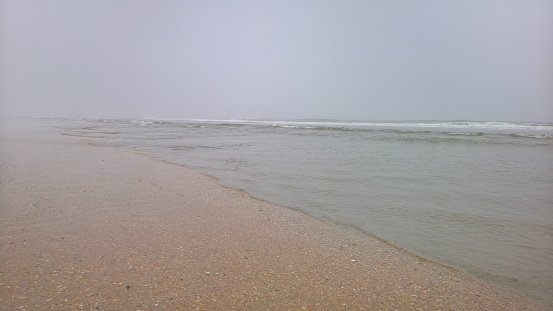 Ocean beach at an angle on a foggy morning