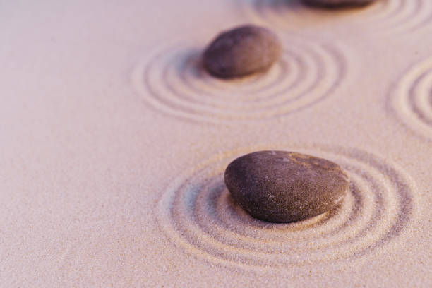 istock Zen garden stones on sand with ornament 1302502179