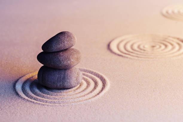 istock Zen garden stones on sand with ornament 1302502265