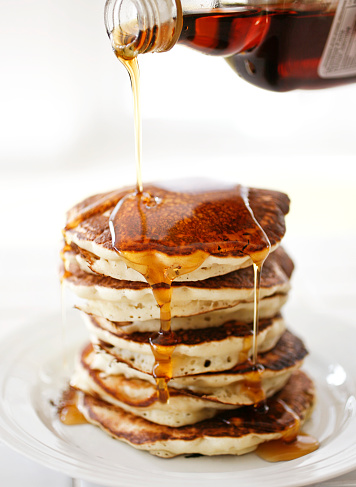 A stack of delicious pancakes covered in maple syrup