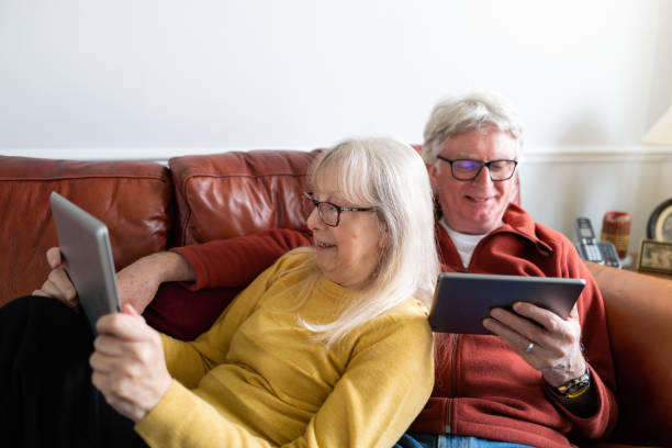 istock Senior couple using digital tablets at home 1302503669