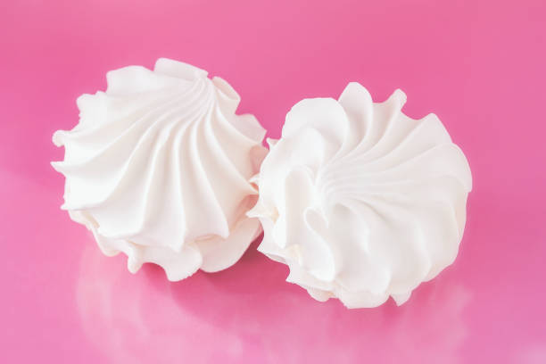 Meringue kisses in white homemade with egg white on white background