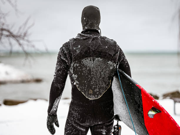 istock Mature man after surfing session in the winter 1302505363