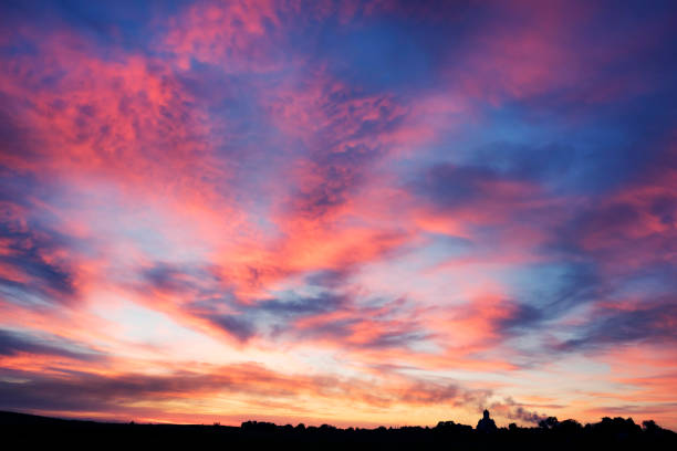 istock dawn rays of sunrise 1302505918