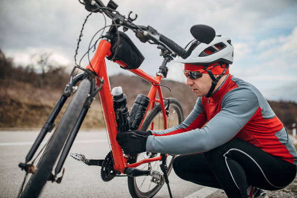 istock Professional cyclist stopped to adjust equipment on bicycle 1302506055