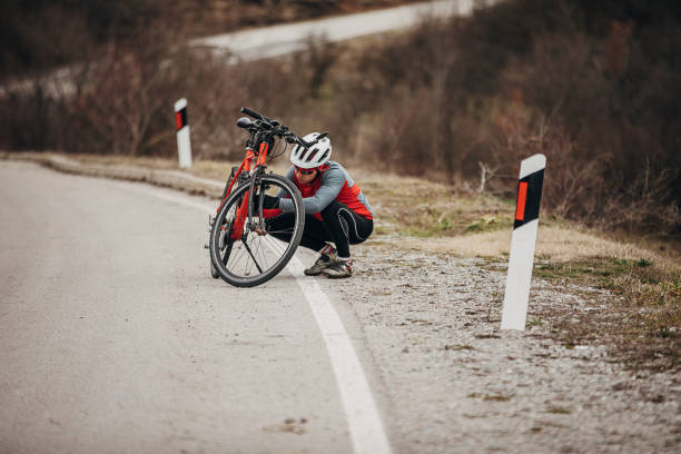 istock Professional cyclist stopped to adjust equipment on bicycle 1302506079
