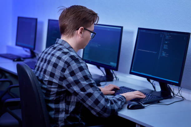 istock A man with black-rimmed glasses is typing on a keyboard. 1302507006