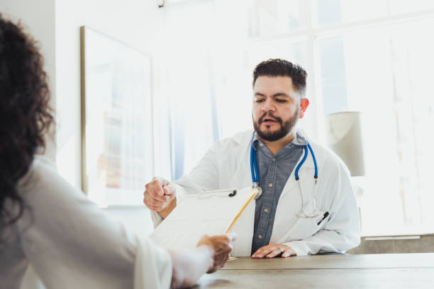 istock Doctor discusses treatment with unrecognizable female patient 1302507214