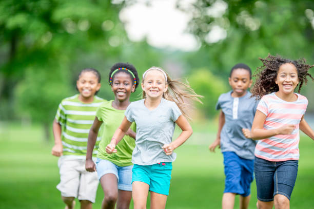 istock Multi ethnic group of children running at a park 1302507262