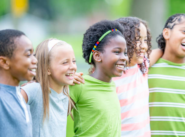 istock Multi ethnic group of children outdoors together 1302507264