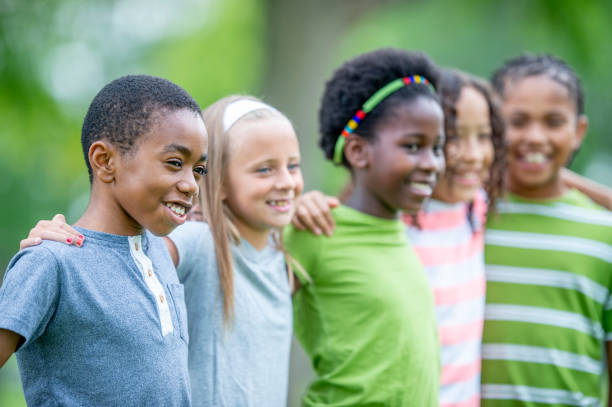 istock Multi ethnic group of children outdoors together 1302507268