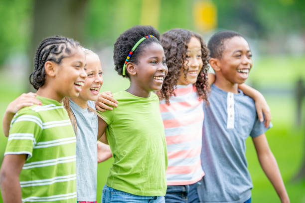 istock Multi ethnic group of children outdoors together 1302507273