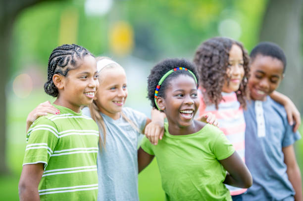 istock Multi ethnic group of children outdoors together 1302507276