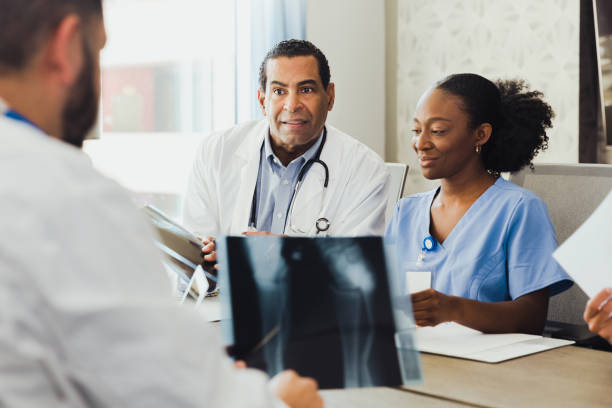 istock Orthopedic doctors consult on patient's x-ray 1302507311