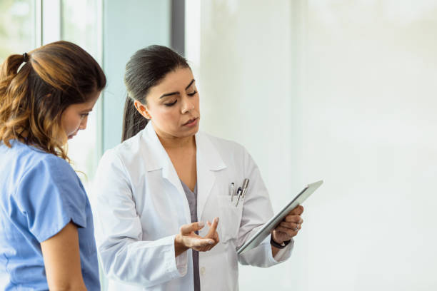 istock Female doctors discuss patient's test results 1302507713