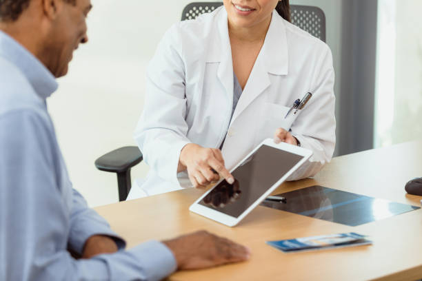 istock Smiling doctor discusses patient's test results 1302507714